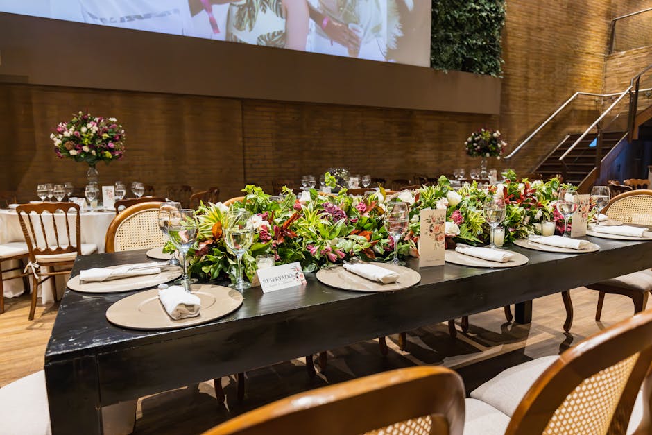 Beautifully decorated table at a luxury wedding reception indoors with floral centerpiece and sophisticated tableware.