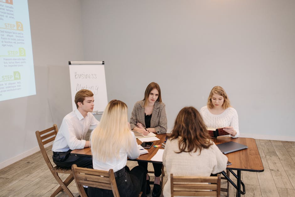Diverse team engaged in a strategic business meeting at an office setting. Collaborative and focused discussion.